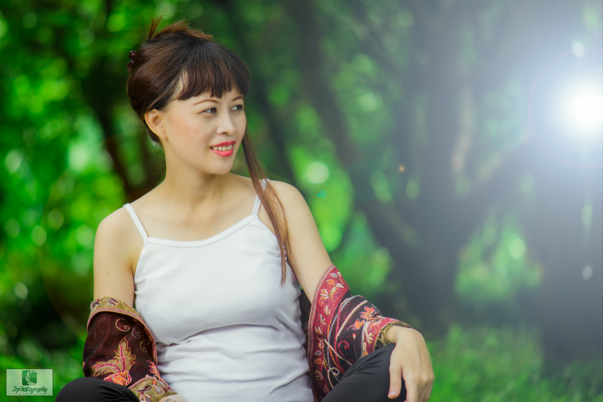 an asian woman in white dress sitting outside