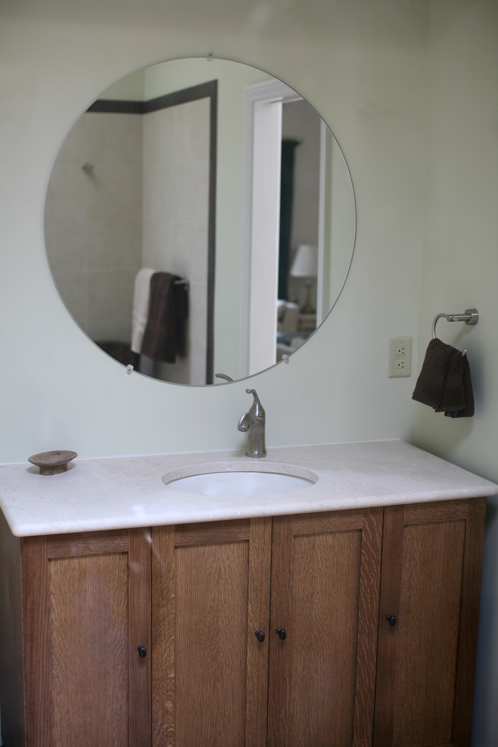 a vanity with a mirror a bowl and a sink