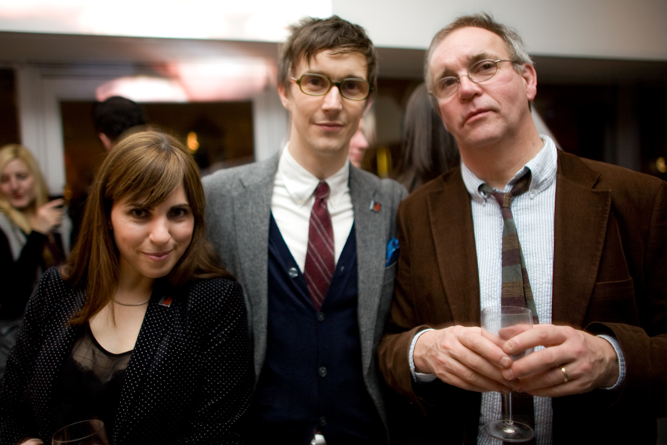 two people and a young person posing for the camera