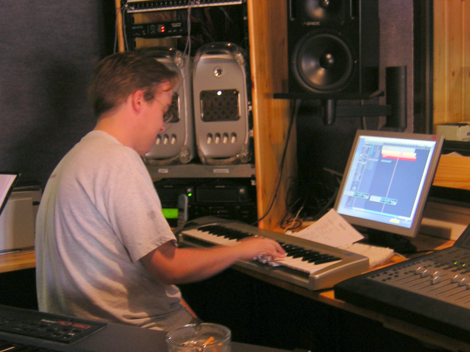 a man in a recording studio, using an electronic piano