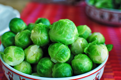 brussel sprouts in a red and white bowl