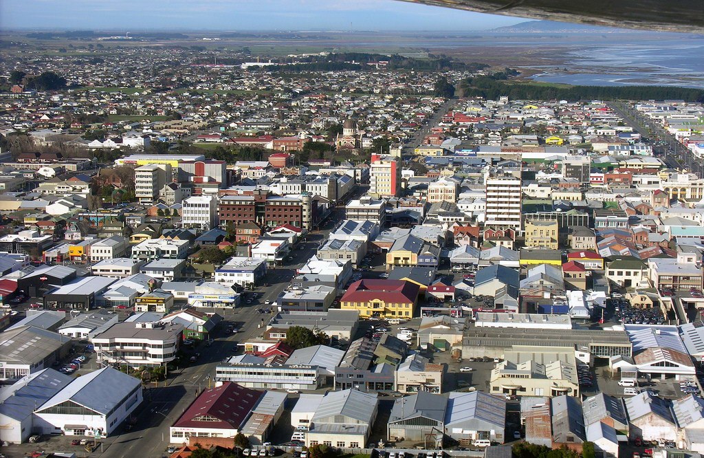 aerial view of small city with water in background