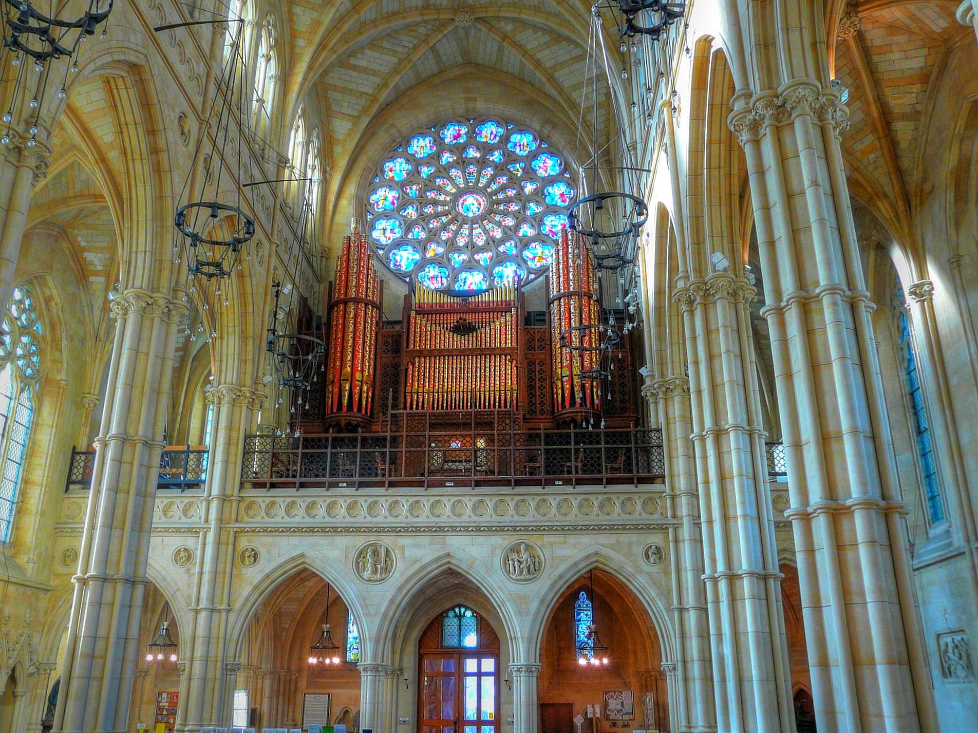 inside of an ornate cathedral with lights and stained glass windows