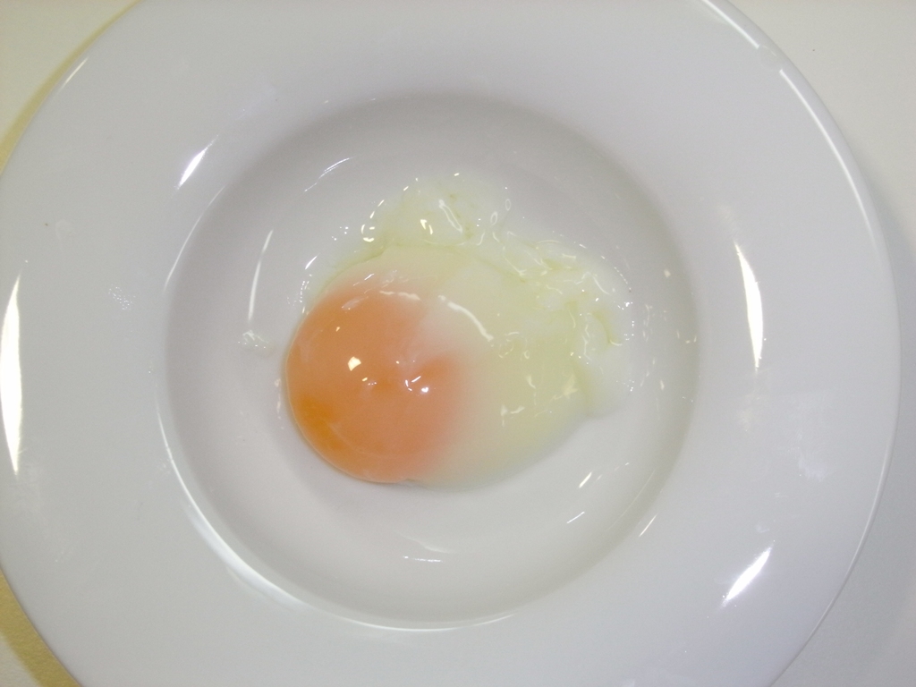 an egg is in the middle of a white plate