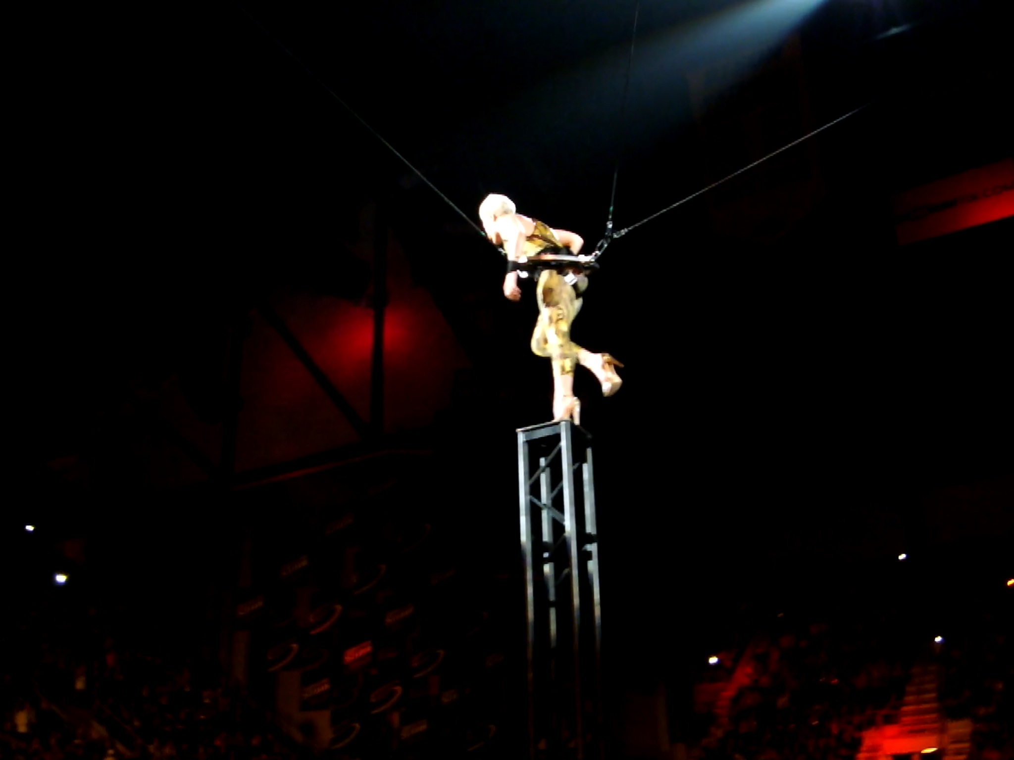 a performer is on a tight rope above a crowd