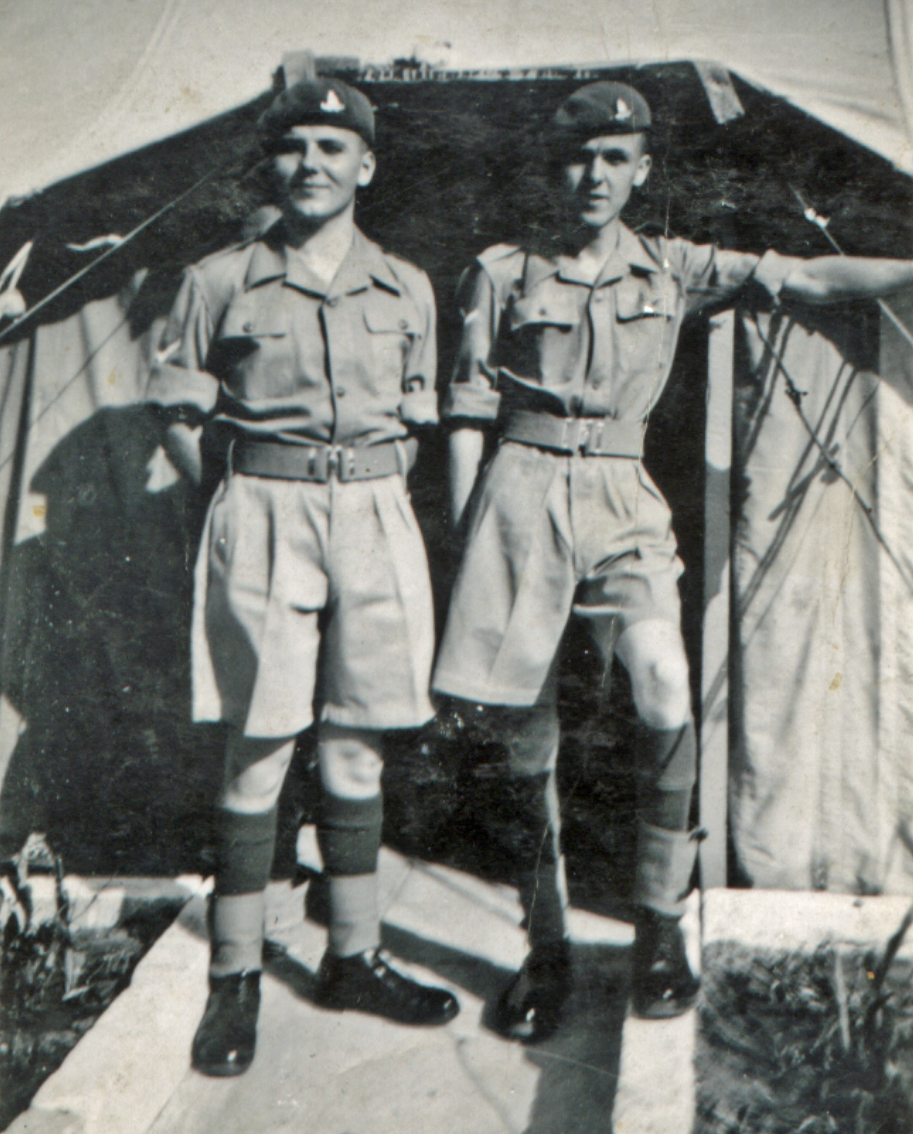 two men in military uniform pose for the camera