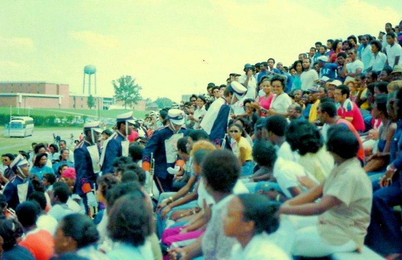 a crowd of people gathered in front of a large building