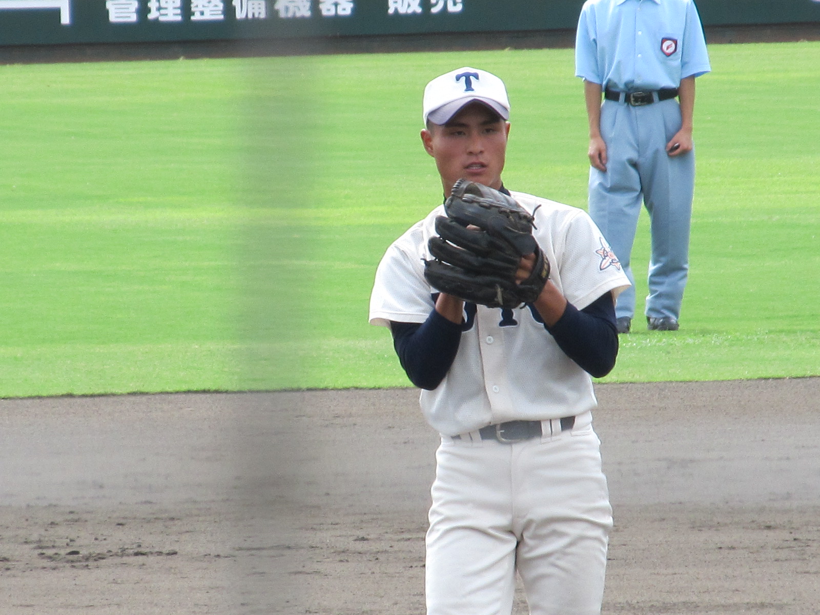 a man wearing baseball gloves is on the field