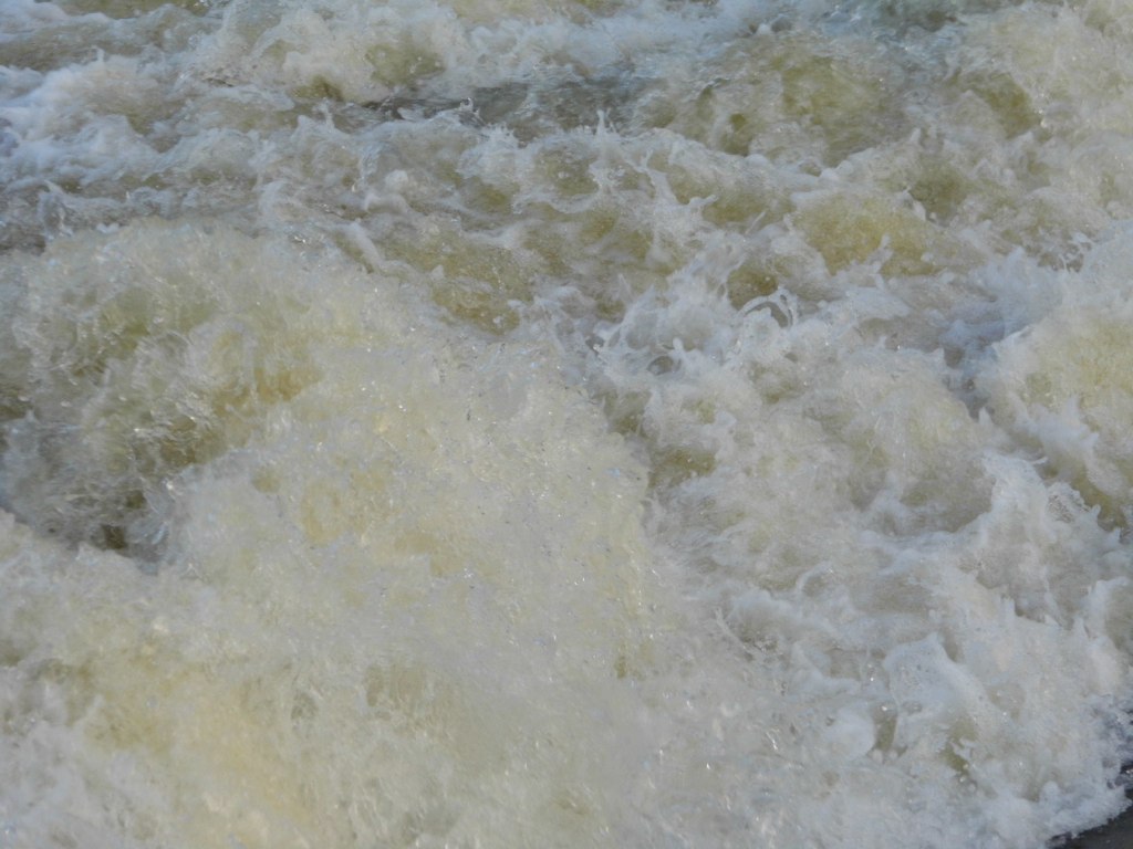 water rushing on top of it in the river