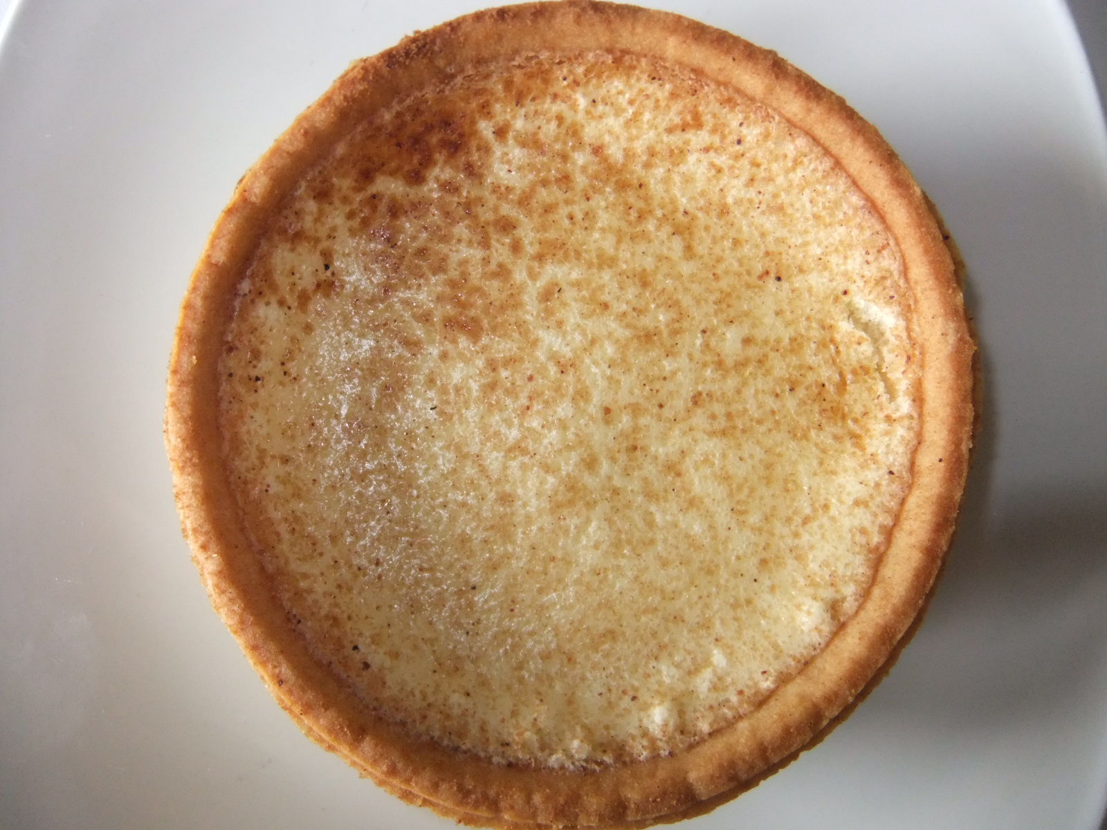 a dessert dessert with sprinkled cream on a white plate