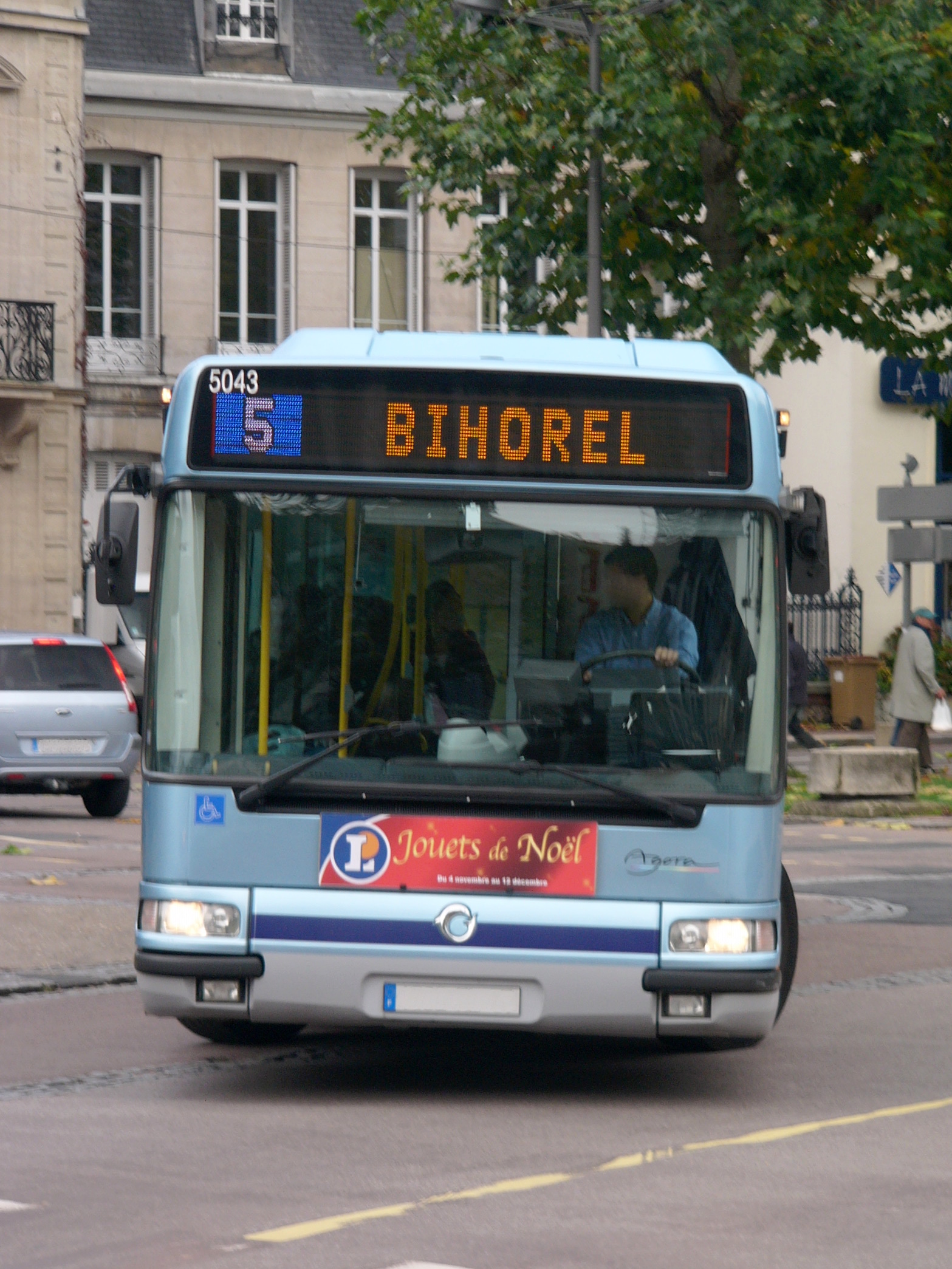 a blue bus is driving on the street