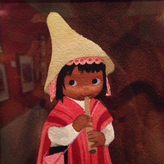 a little girl doll with a big white hat on her head