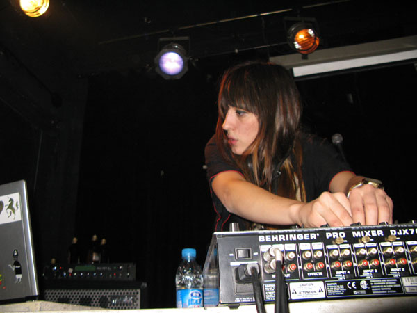 a young woman mixing in front of a recording equipment