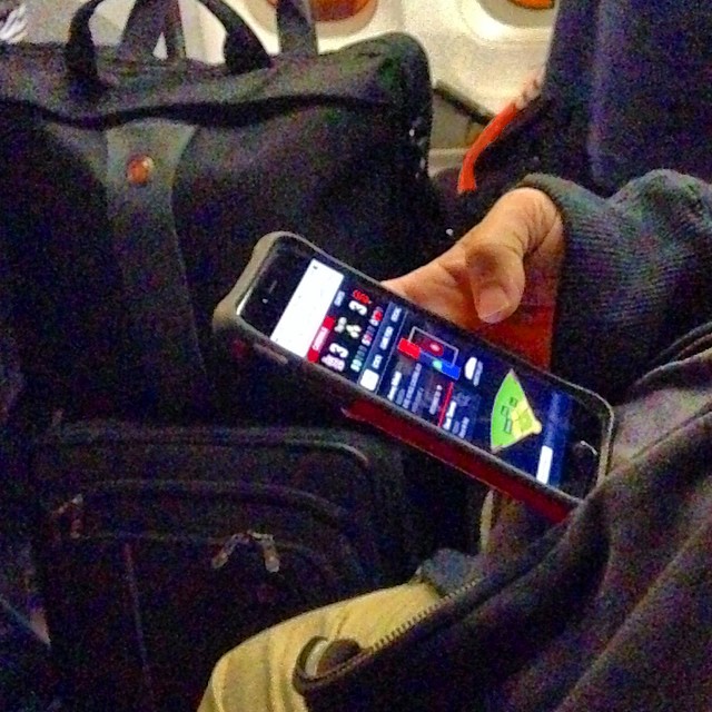 someone using a cell phone on an airplane