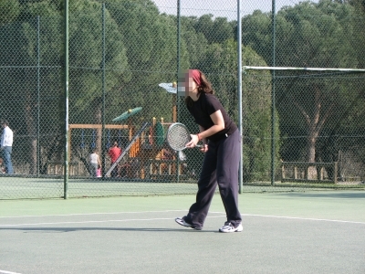 a tennis player holding a racket at the court