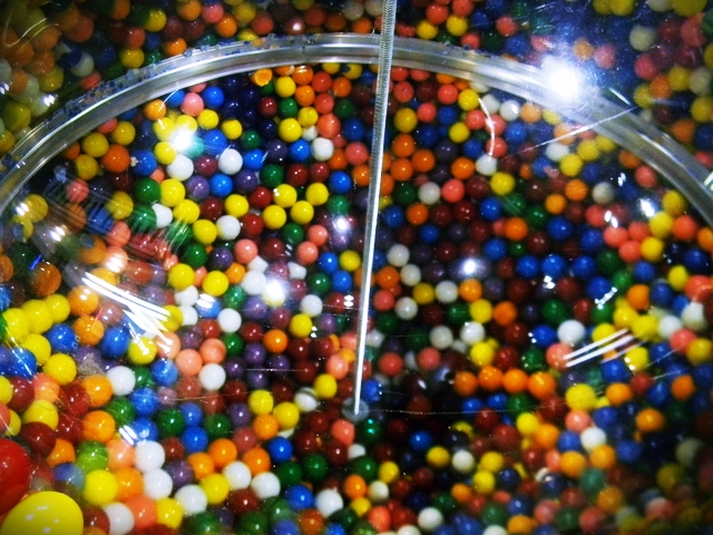 a round glass with lots of different colored balls inside