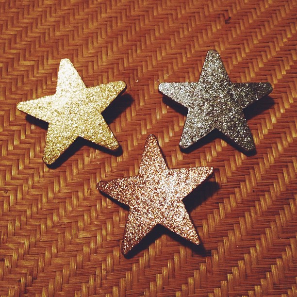 three shiny stars are arranged on a mat