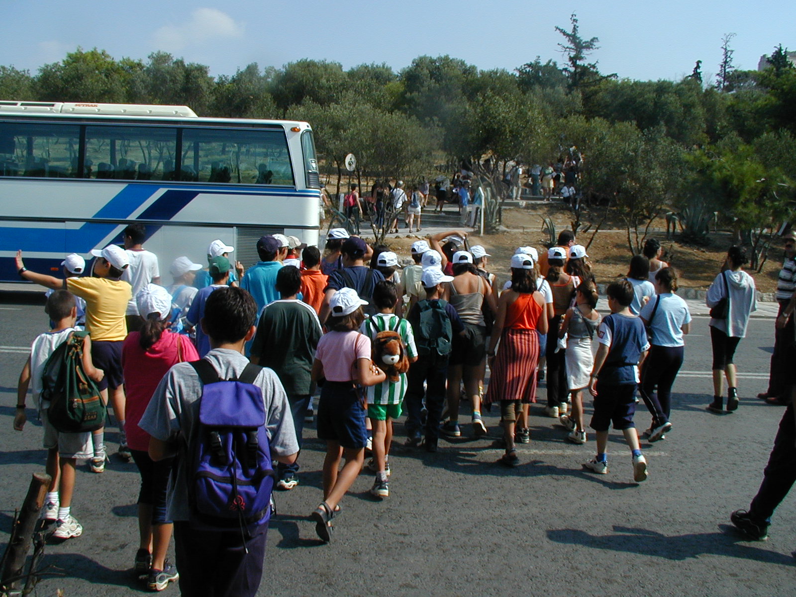 a group of people in front of a bus