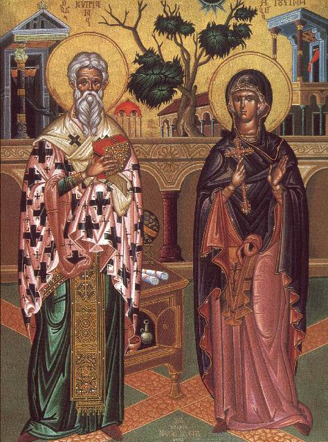 two saints standing next to each other with a tree in the background