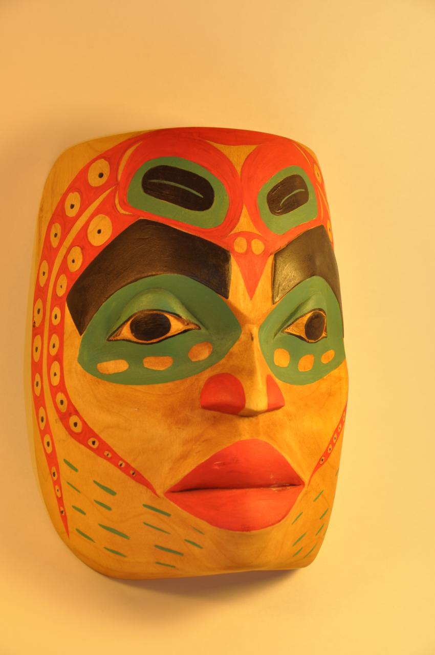 an image of a decorative mask hanging from the wall