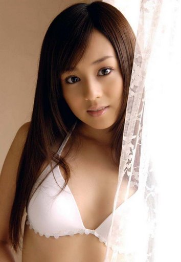 beautiful asian woman in white  posing for the camera