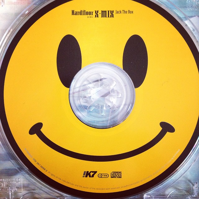a yellow and black smiley face shaped plastic disc