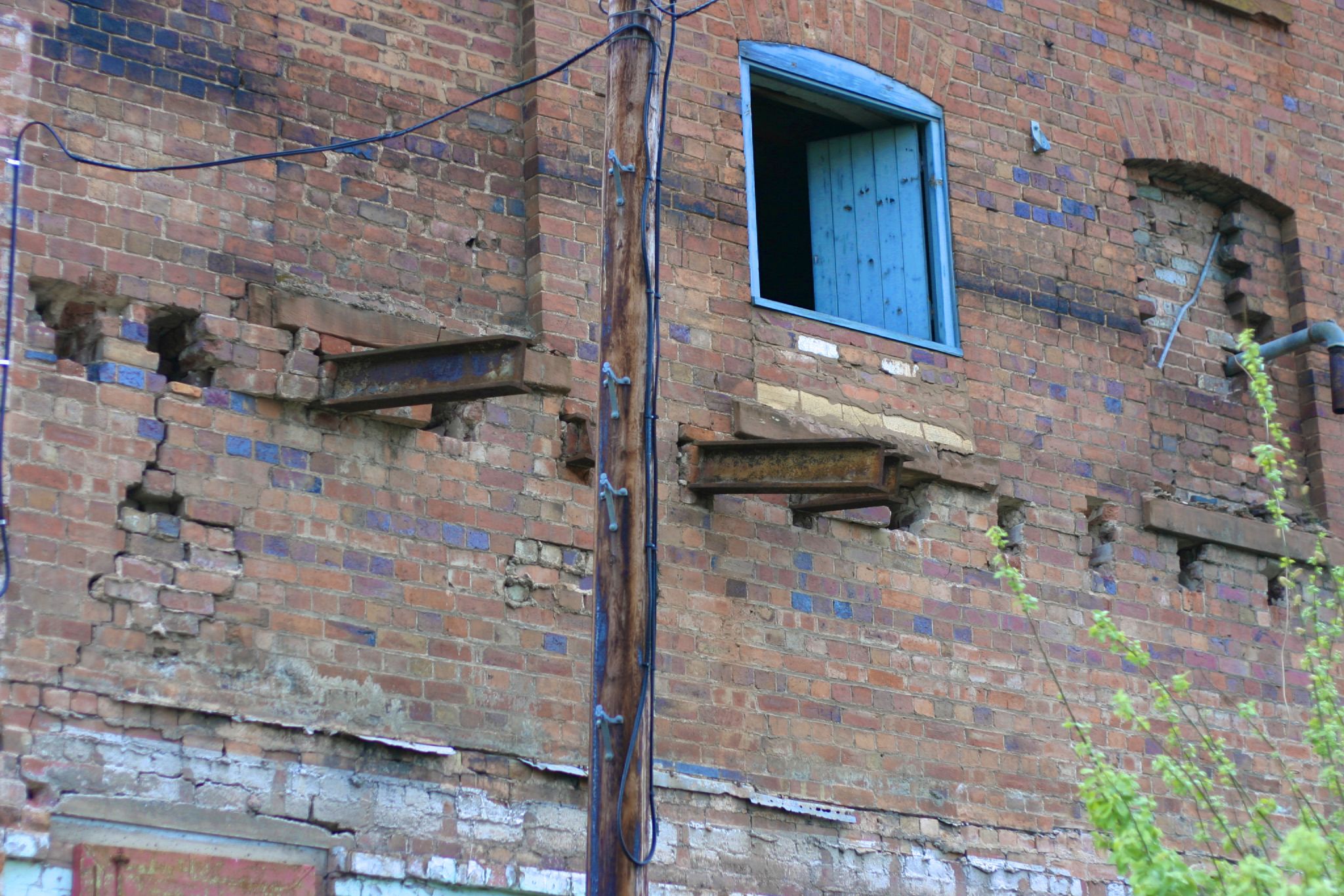 an old building with blue glass on the windows