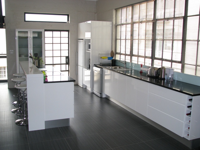 a kitchen filled with black counters and appliances