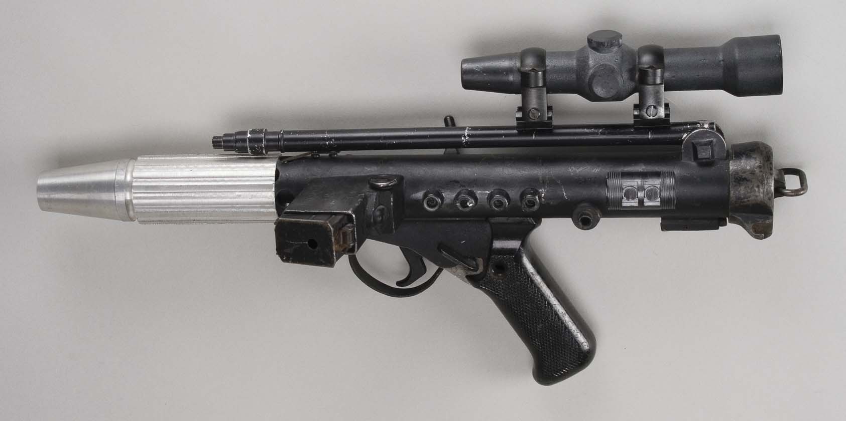 an antique gun mounted to the side of a wall