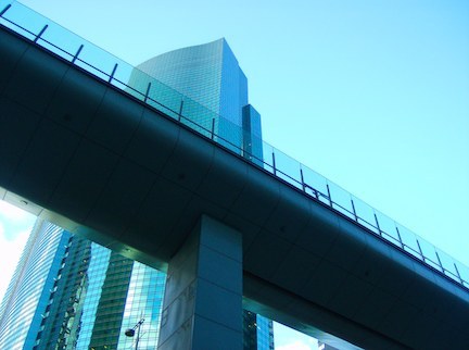 a very tall building with a bridge above it