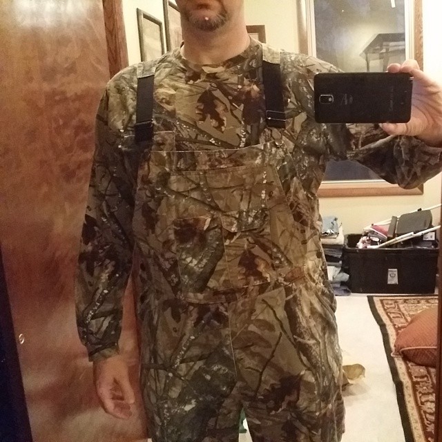 a man wearing a camouflage uniform taking a selfie