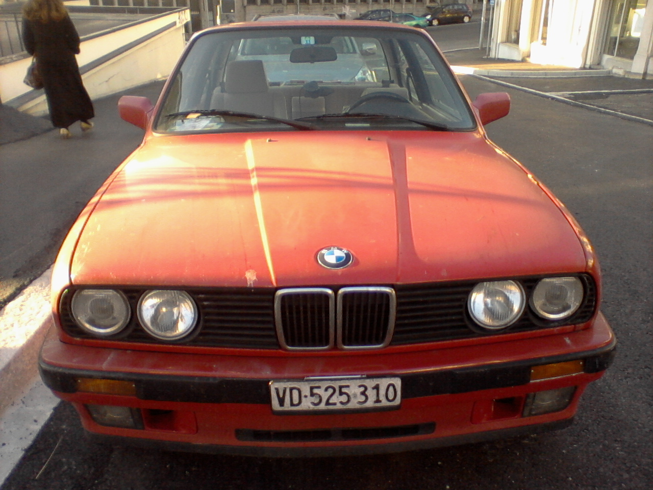 a red car parked near the side of a street