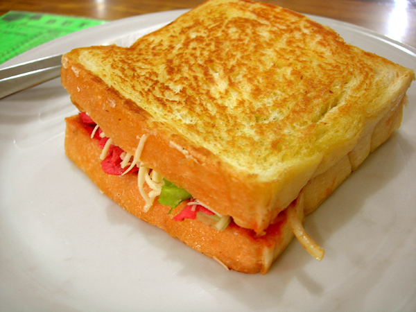 a grilled cheese sandwich on a white plate