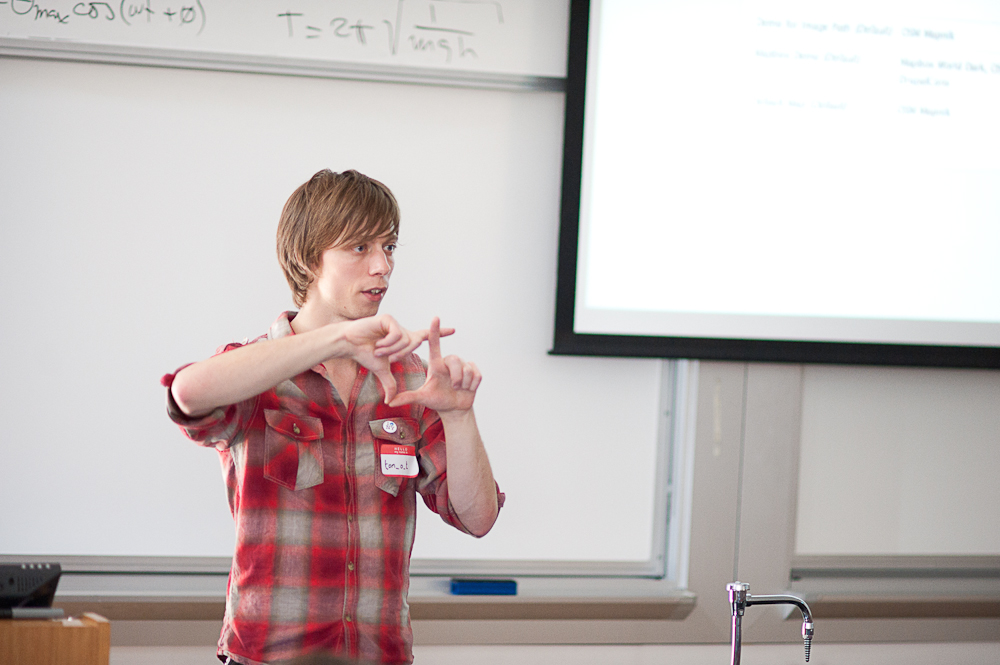 a boy that is standing in front of a projector screen