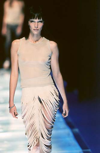 woman in a dress on a runway with short hair