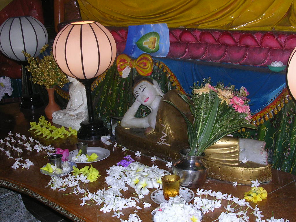 the colorful display of a buddha statue and other items is displayed