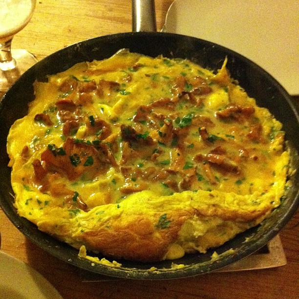 a cheesy breakfast dish in a cast iron set