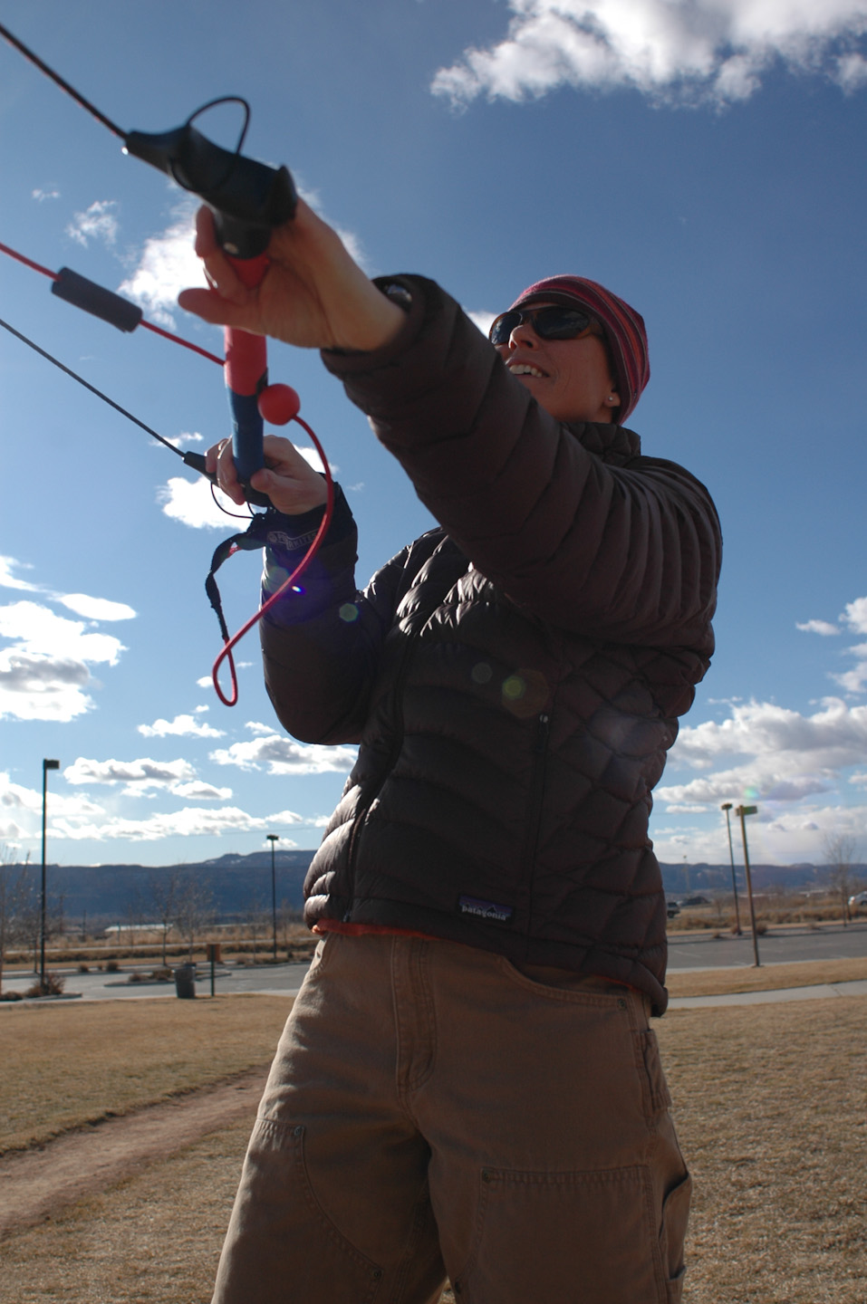 a person standing in the grass holding onto some kind of equipment