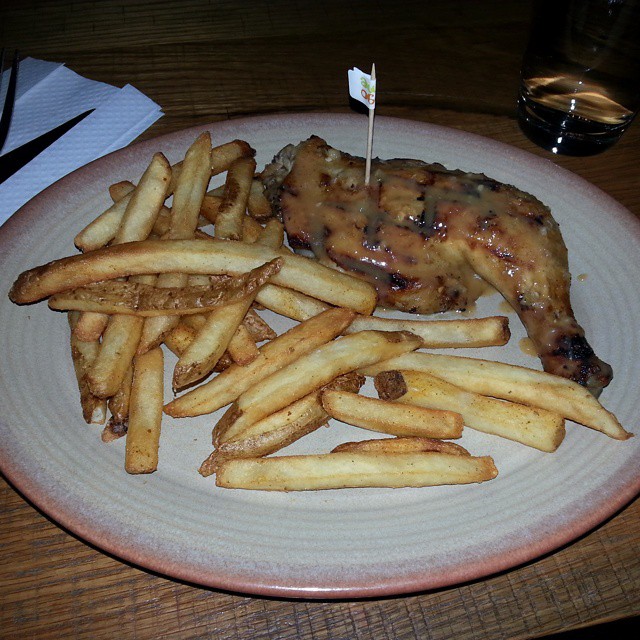 a plate of food with meat and french fries on it