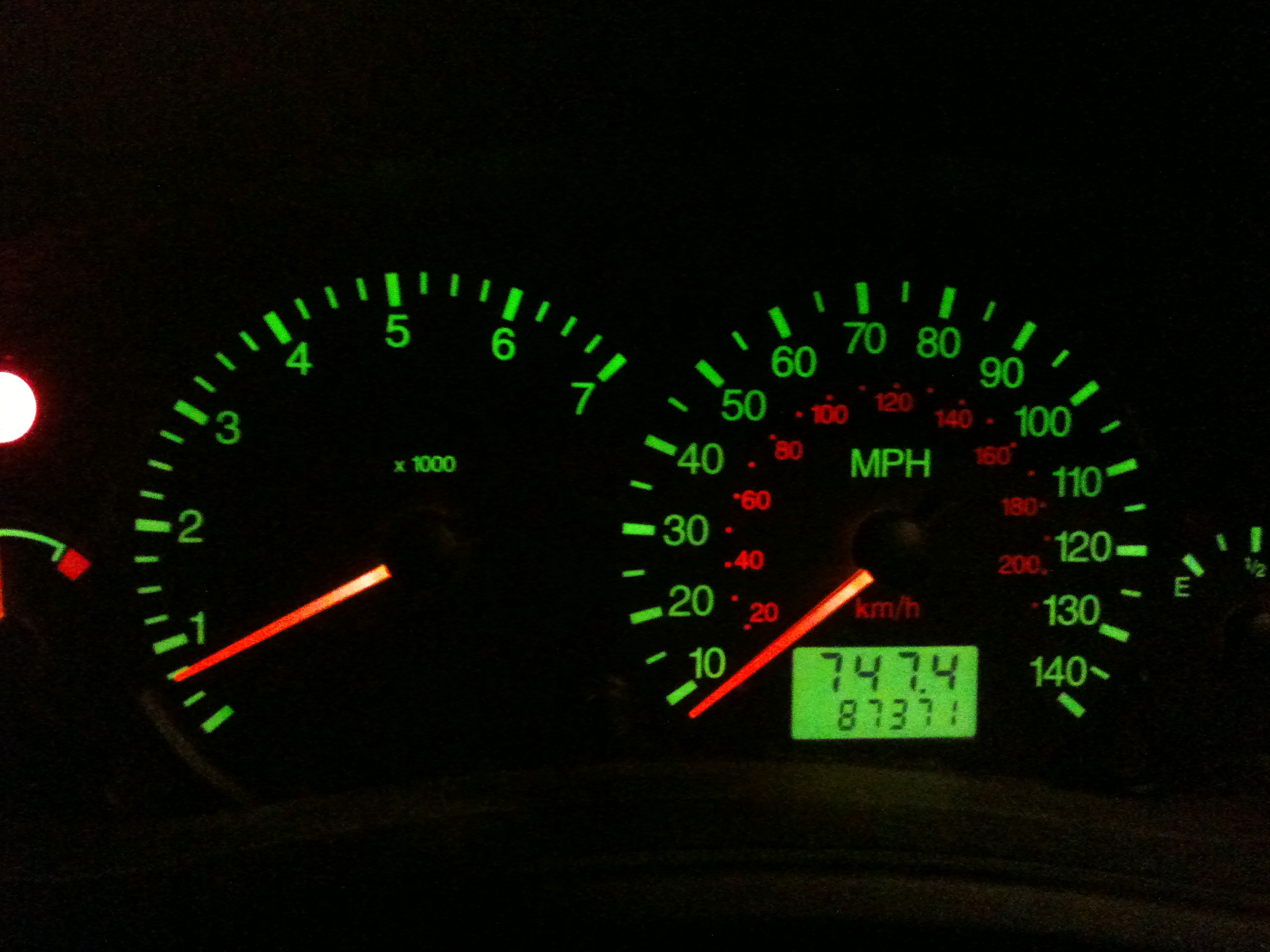 the dashboard of a car with glow on it