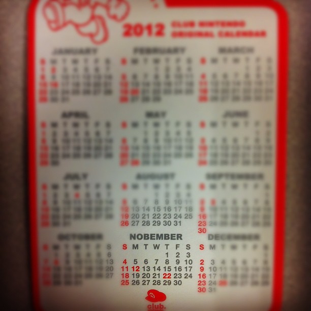 a red calendar with a white sticker on it