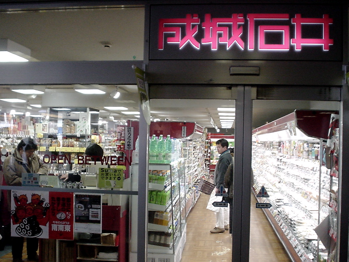 a man inside a liquor store looking in the store's glass doors