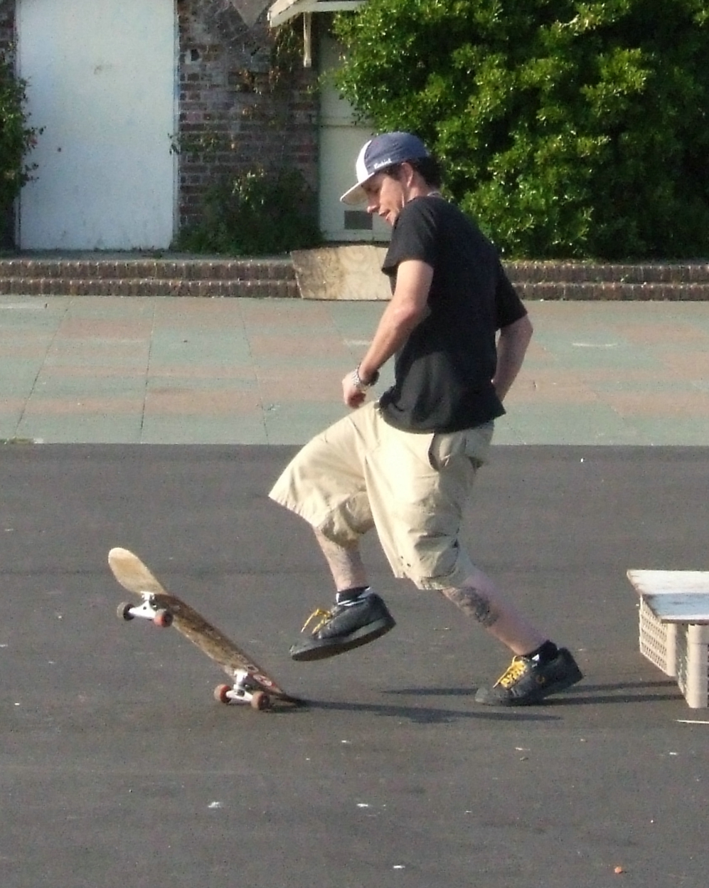 man in black shirt riding on top of skateboard