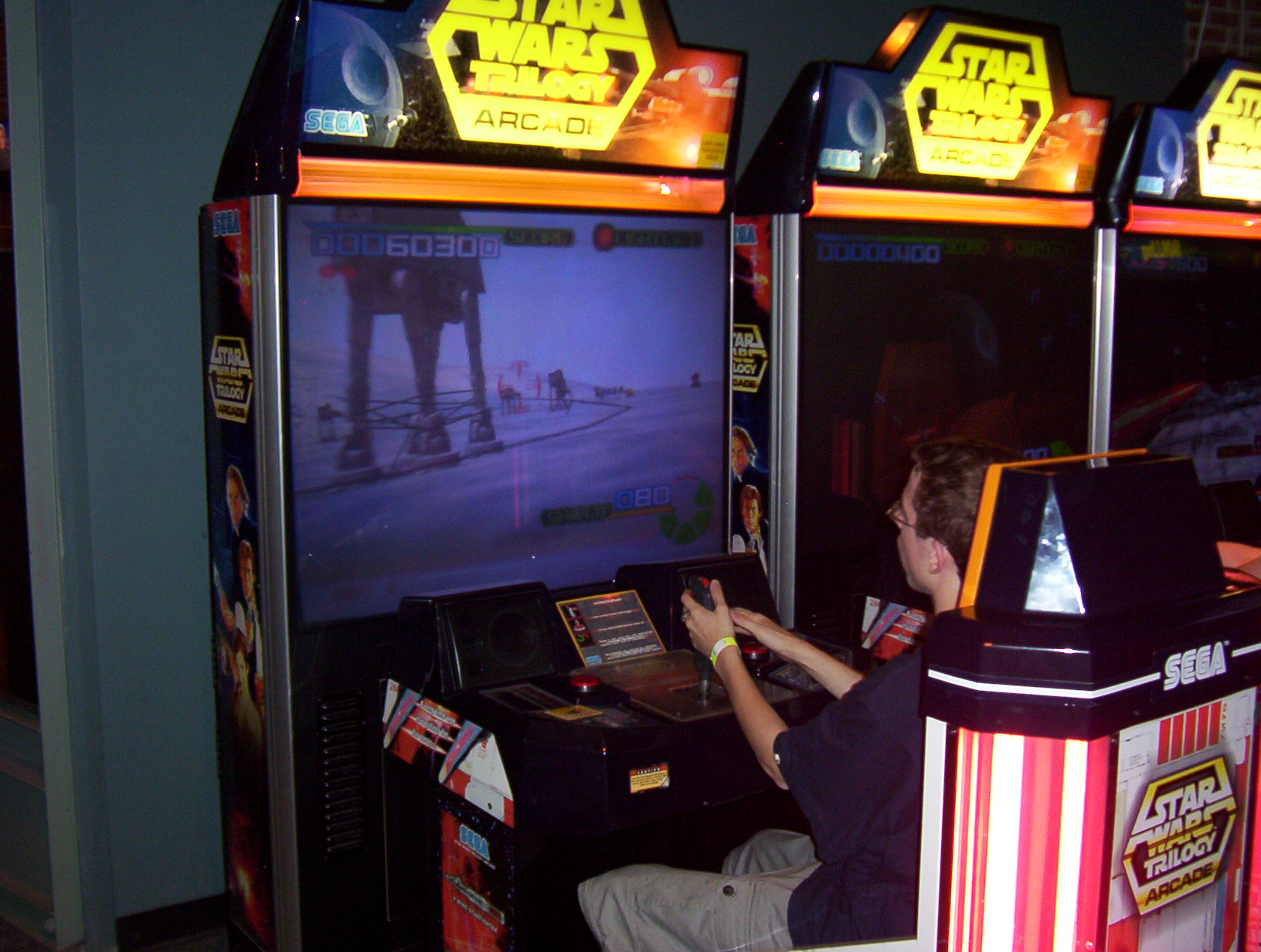 a boy playing an arcade video game