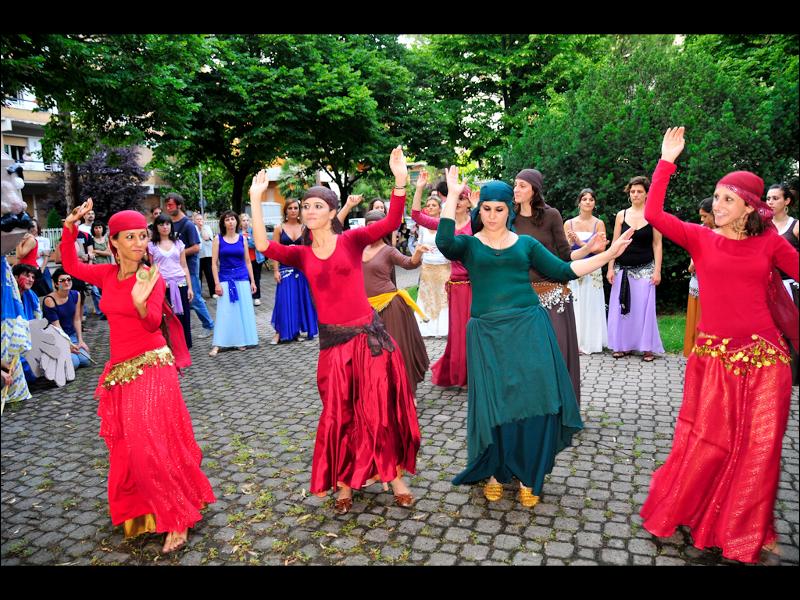 women are dancing in the middle of a crowd