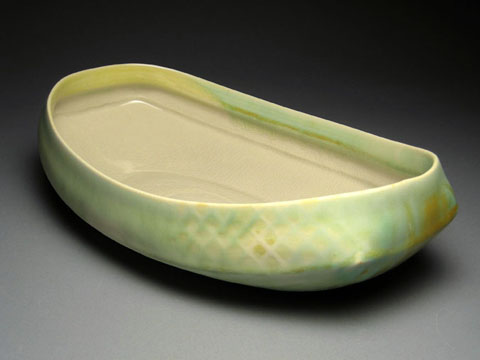 a ceramic bowl on black with an edge