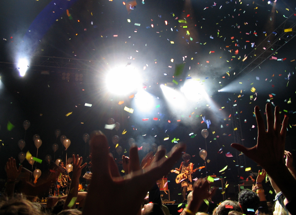 a crowd of people standing on top of a stage