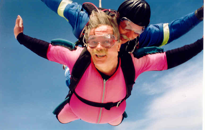 the two people in diving suits are floating upside down