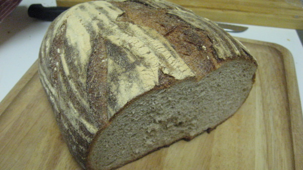 a big loaf of bread sitting on top of a  board