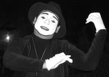 a clown has his hands extended while performing